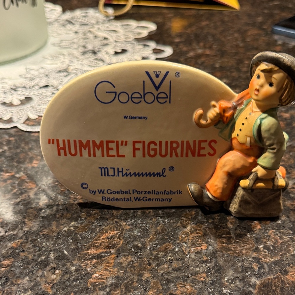 Hummel Figurine #187A.  It is a Hummel Figurines sign with Merry Wanderer.